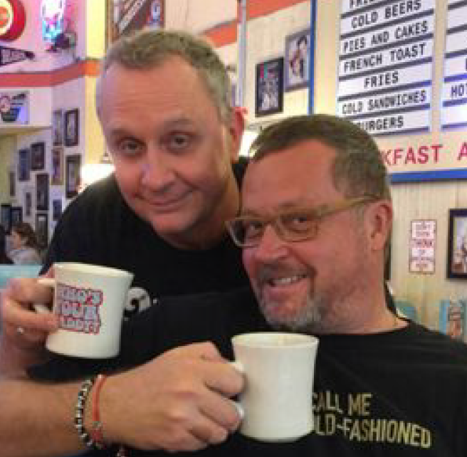 Mark McNease and Rick Rose holding up coffee cups